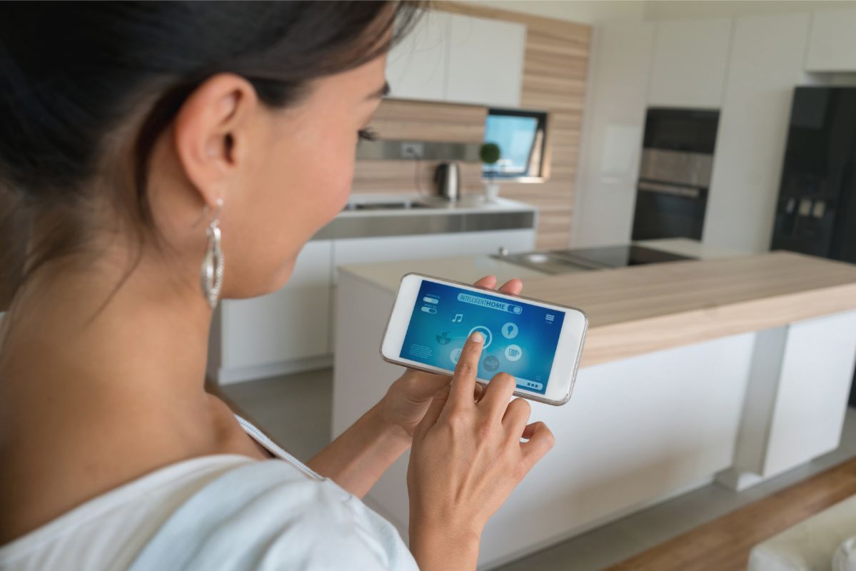 Woman using smart home app on her cell phone